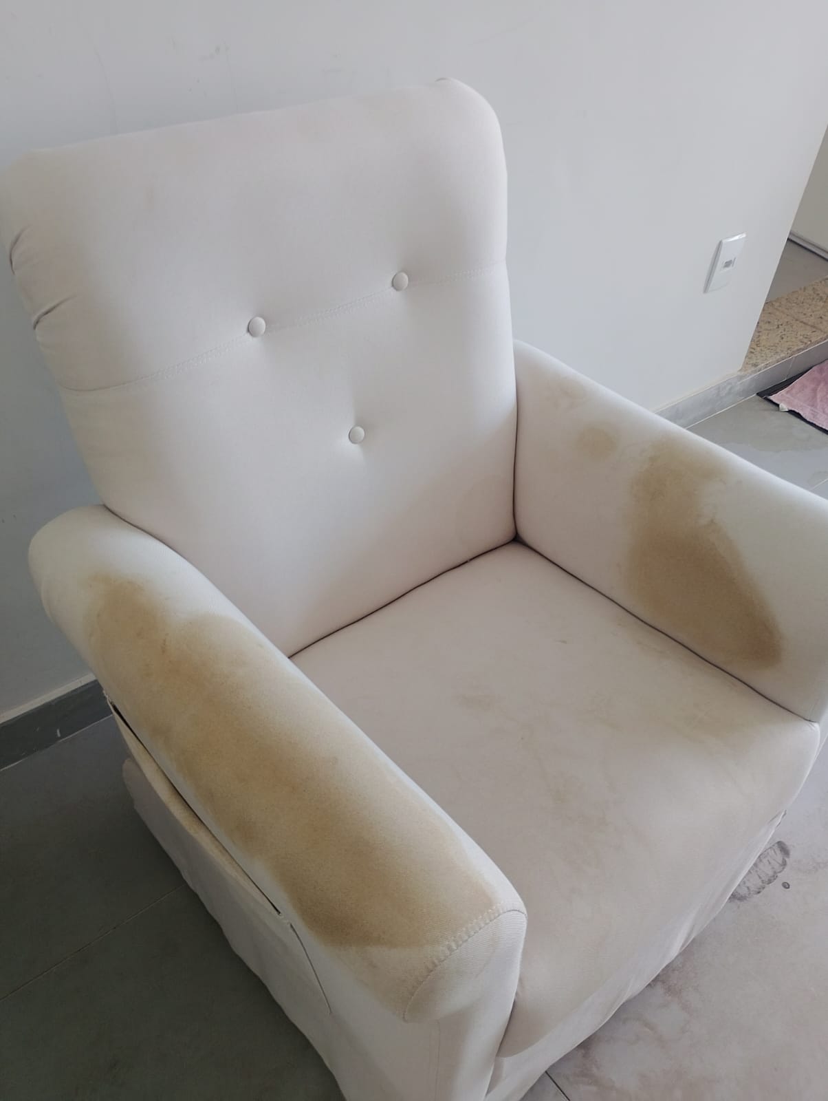 A mesma poltrona com manchas, antes da higienização